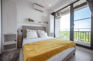 Ένα ή περισσότερα κρεβάτια σε δωμάτιο στο Serenity by Oxygen Residence