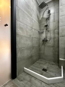 a shower with a glass door in a bathroom at Thea comfy living in Nea Vrasna