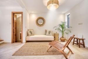 a living room with a couch and a chair at Villa Bali Cocoon - Piscine - luxe - 4 or 5 Px in Agadir