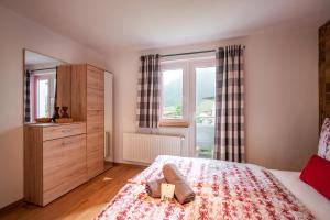 a bedroom with a bed and a dresser and a window at Apartment Eve in Söll