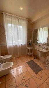 a bathroom with two sinks and two mirrors at Appartamento San Lorenzo in Pescantina +42 photos