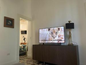 a television sitting on a stand in a living room at Ale e Nino in Chieti