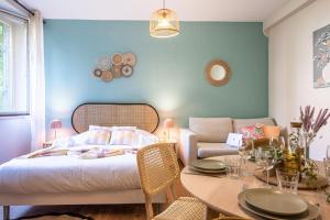 a bedroom with a bed and a table and a couch at Centre - L'escale - Petite France in Strasbourg