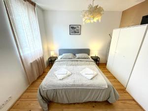 um quarto com uma cama com duas almofadas em Charmant 2 pièces atypique em Mulhouse