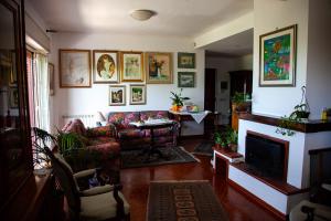 a living room with a couch and a fireplace at MAGIA & EMOZIONI - Trecastagni- Area etnea Villa vista mare in Trecastagni