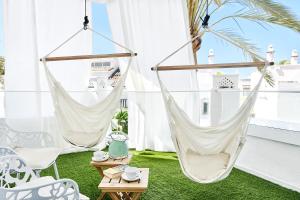 two hammocks on a balcony with green grass at Iberostar Selection Marbella Coral Beach in Marbella