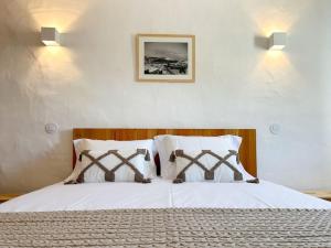 a bedroom with a bed with two teddy bears on it at Casa das Piteiras nº3 - Aljezur in Aljezur