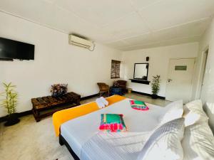a bedroom with a bed and a living room at LOUIS LAKE VILLA in Kandy