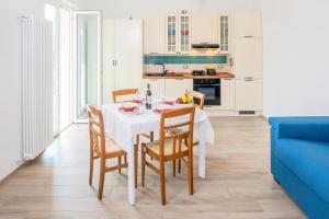 a kitchen and dining room with a table and chairs at Villa Rosetta & Romeo Family Apartment in Costermano sul Garda