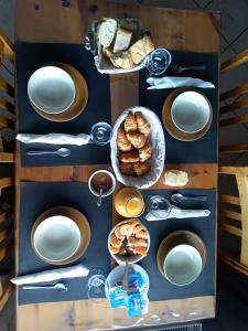 a shelf with white plates and bread on it at Auberge du Col du Festre in Le Dévoluy