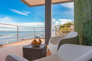 a bowl of fruit on a table on a balcony at GT Seaside Inn in Oslob