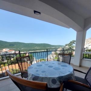 a table and chairs on a balcony with a view at Villa Dian in Neum