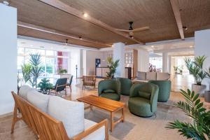 a living room with couches and chairs and a table at HG Jardín de Menorca in Son Bou