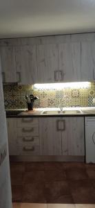 a kitchen with a sink and a counter top at Casa Cueva El Almendro in Pegalajar