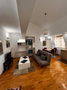 a living room with a couch and a table at VORTEX Apartment Skopje in Skopje