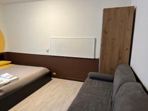 a room with a bed and a chalkboard on the wall at Sant Antonino Metro Pozzo Strada in Turin