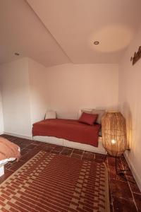 1 dormitorio con 1 cama con manta roja en Carcassonne mon amour, en Carcassonne