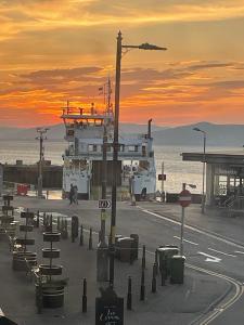a ferry yard with a sunset in the background at Ferry View in Largs