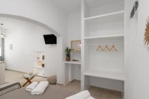 a living room with white walls and a fireplace at Agathi's House in Triovasálos