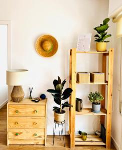 a room with a dresser and a shelf with plants at Fantástico piso en Tossa de Mar in Tossa de Mar