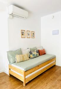 a couch with pillows on it in a room at Fantástico piso en Tossa de Mar in Tossa de Mar