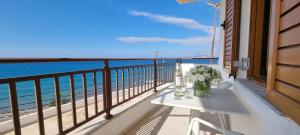 a white table on a balcony with a view of the ocean at Simon Sea View in Sitia