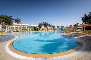 a large swimming pool at a resort with palm trees at Labranda Royal Makadi in Hurghada