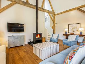 a living room with a couch and a fireplace at Hatchers Barn - Uk42080 in East Garston