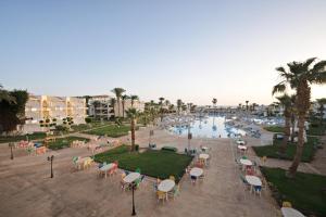 a resort with a pool and chairs and palm trees at Labranda Club Makadi in Hurghada