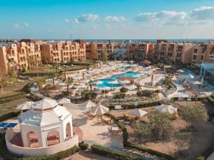 an aerial view of a resort with pools and umbrellas at Lemon & Soul Makadi Garden in Hurghada +52 photos