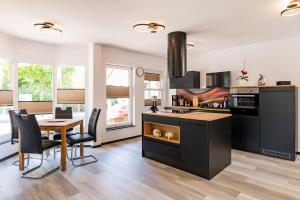 a kitchen with a table and a dining room at Ferienwohnung Hopf in Bad Liebenstein