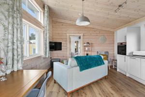 a living room with a couch and a table at Croftner, Great Field Lodges in Braunton
