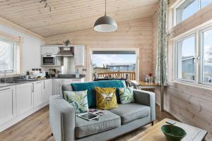 a living room with a couch and a kitchen at Croftner, Great Field Lodges in Braunton