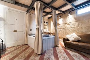 a living room with a couch and a window at Palazzo Mandurino luxury relais in Zollino
