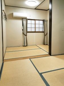 an empty room with a door and a window at HOTEL HOUSE LEE in Tokyo