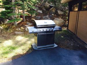 a stove sitting in a yard next to a house at Mammoth Point by 101 Great Escapes in Mammoth Lakes