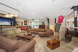 a large living room with couches and a fireplace at Tenjin Lodge in Minakami