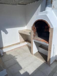 an outdoor pizza oven with a brick oven at Beato Typical House in Lisbon