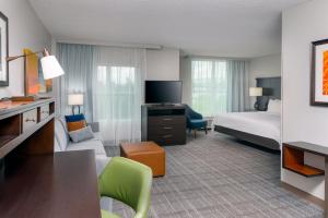 a hotel room with a bed and a living room at Staybridge Suites Miami Doral Area, an IHG Hotel in Miami
