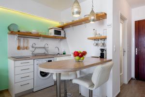 a kitchen with a table with apples on it at Seaside Secret by BluPine in Athens