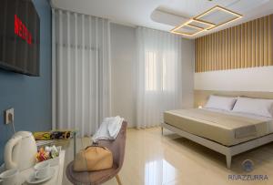 a bedroom with a bed and a tv in it at Rivazzurra Beach Rooms in San Vito lo Capo