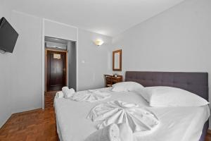 Postel nebo postele na pokoji v ubytování Minerva Hotel