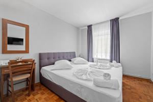 Postel nebo postele na pokoji v ubytování Minerva Hotel