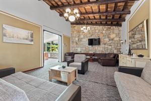 a living room with a couch and a table at Minerva Hotel in Medulin