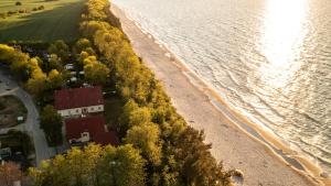 an aerial view of a beach next to the water at Nad brzegiem Bałtyku in Sarbinowo