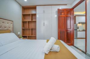 a bedroom with a bed with two towels on it at Spring Hill Apartment -The High Class in Ho Chi Minh City