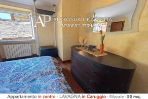 a bedroom with a bed and a dresser in a room at Il Borgo dall'alto in Lavagna