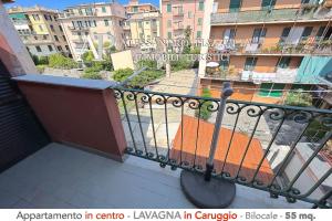 a balcony with a view of a city with buildings at Il Borgo dall'alto in Lavagna