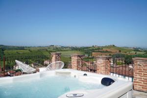 a jacuzzi tub on the balcony of a house at La Butte de Viaris in Viarigi