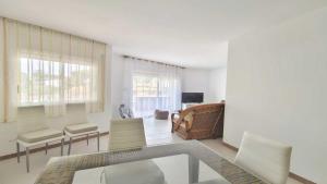 a living room with a glass table and chairs at Apartamento Costamar by VACAY L'Escala in L'Escala